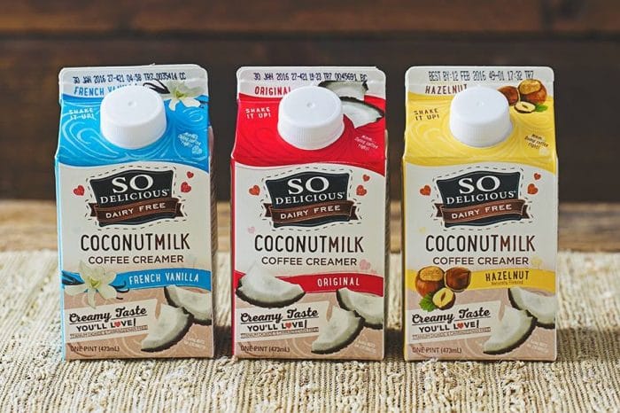 three different flavors a branded vegan coffee creamer in cartons