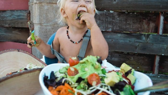 kid enjoys eating vegetables